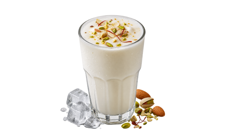 Glass of white lassi topped with chopped nuts and saffron strands