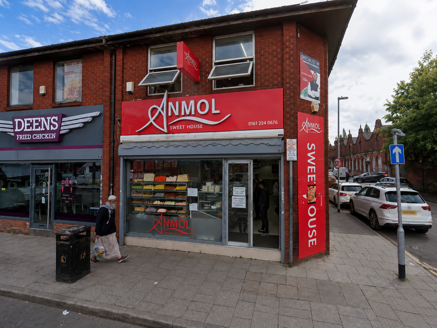 Anmol Sweet House shopfront with red signage on a Manchester high street